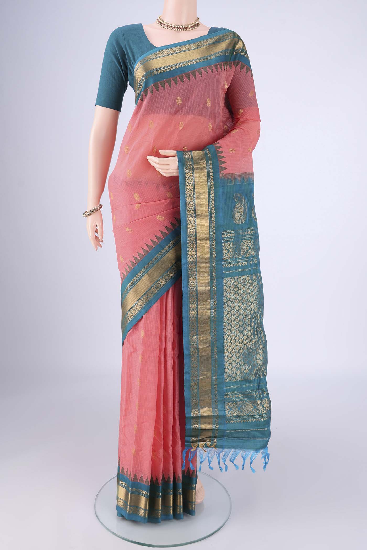Coral Gadwal Silk Cotton Saree with Zari Butta on the body and Silk Border.  displayed on a mannequin