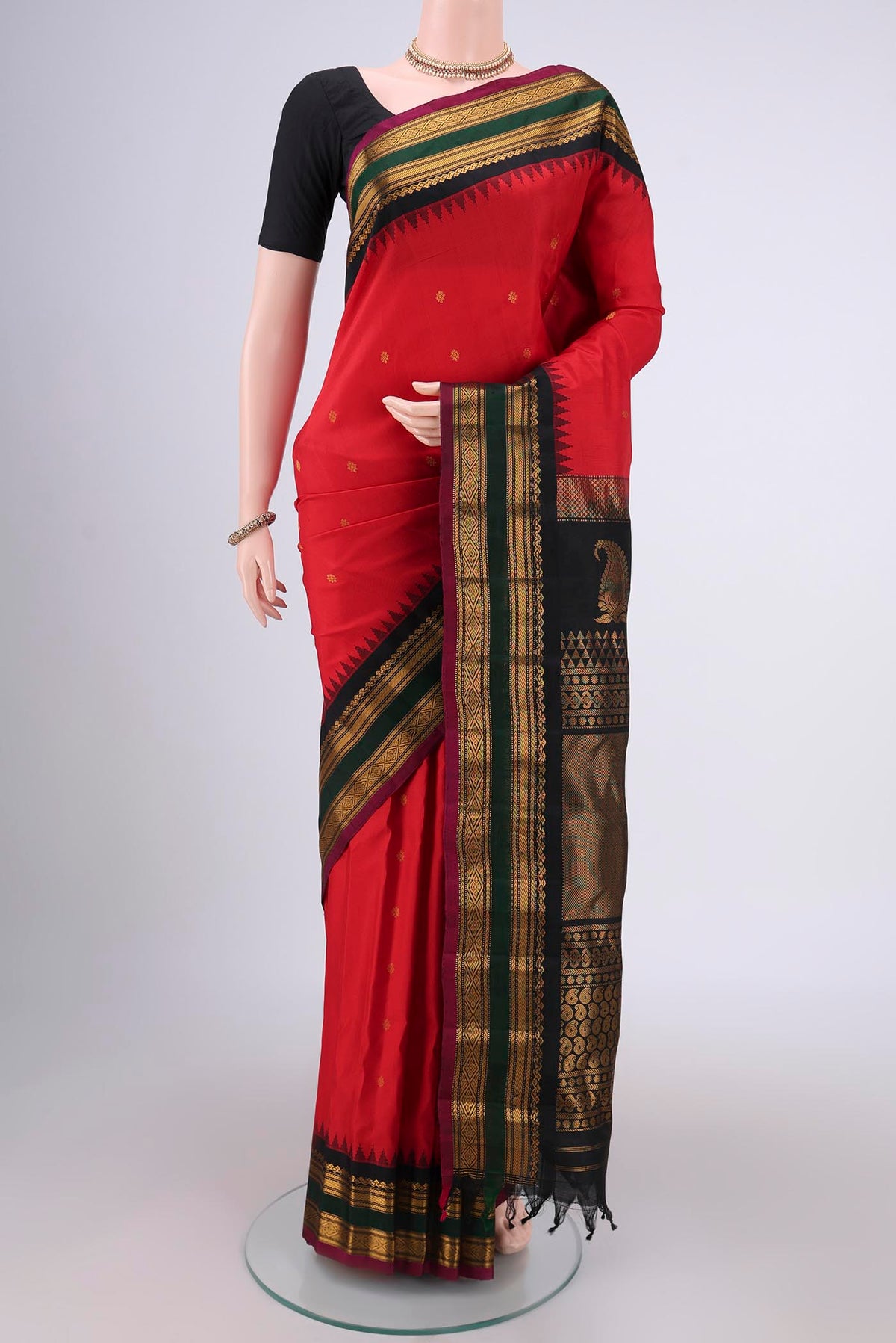 Red Gadwal Silk Saree with Zari Butta on the body and Zari Border.  displayed on a mannequin