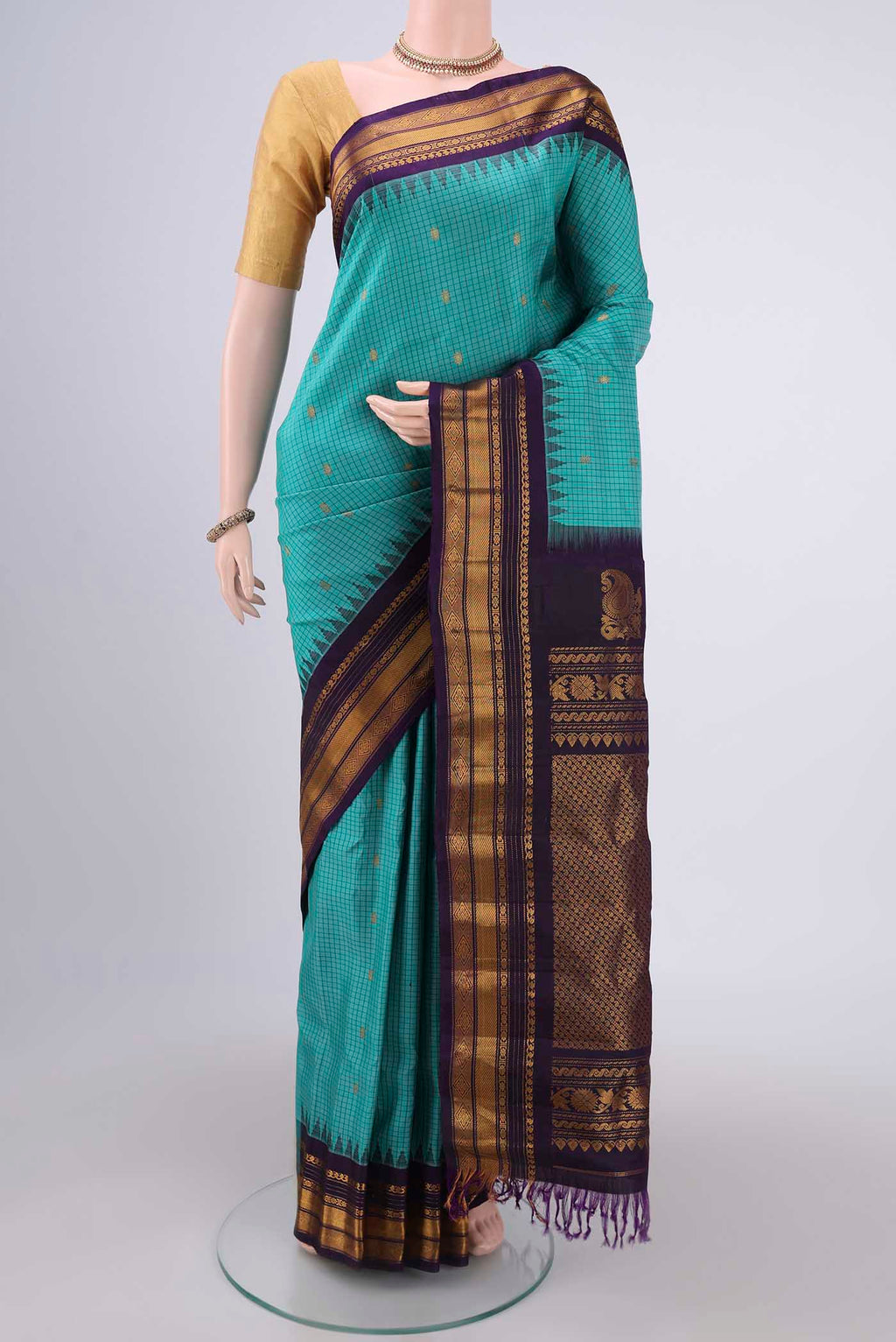 Turquoise Gadwal Silk Saree with Checked design on the body and Zari Border.  displayed on a mannequin