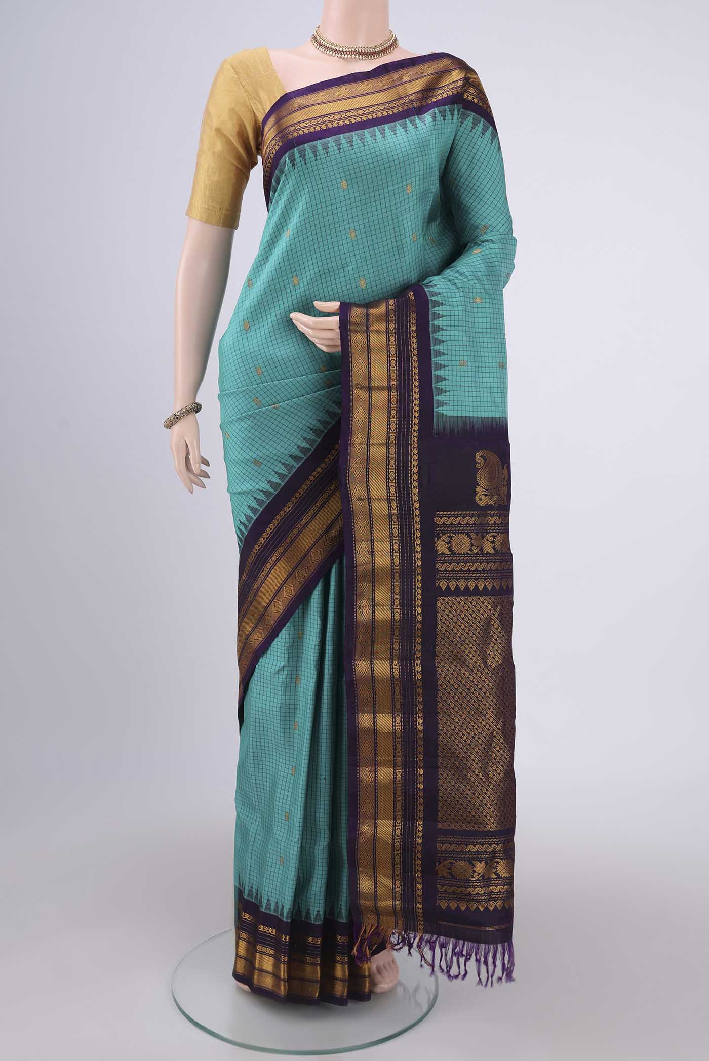 Turquoise Gadwal Silk Saree with Checked design on the body and Zari Border.  displayed on a mannequin