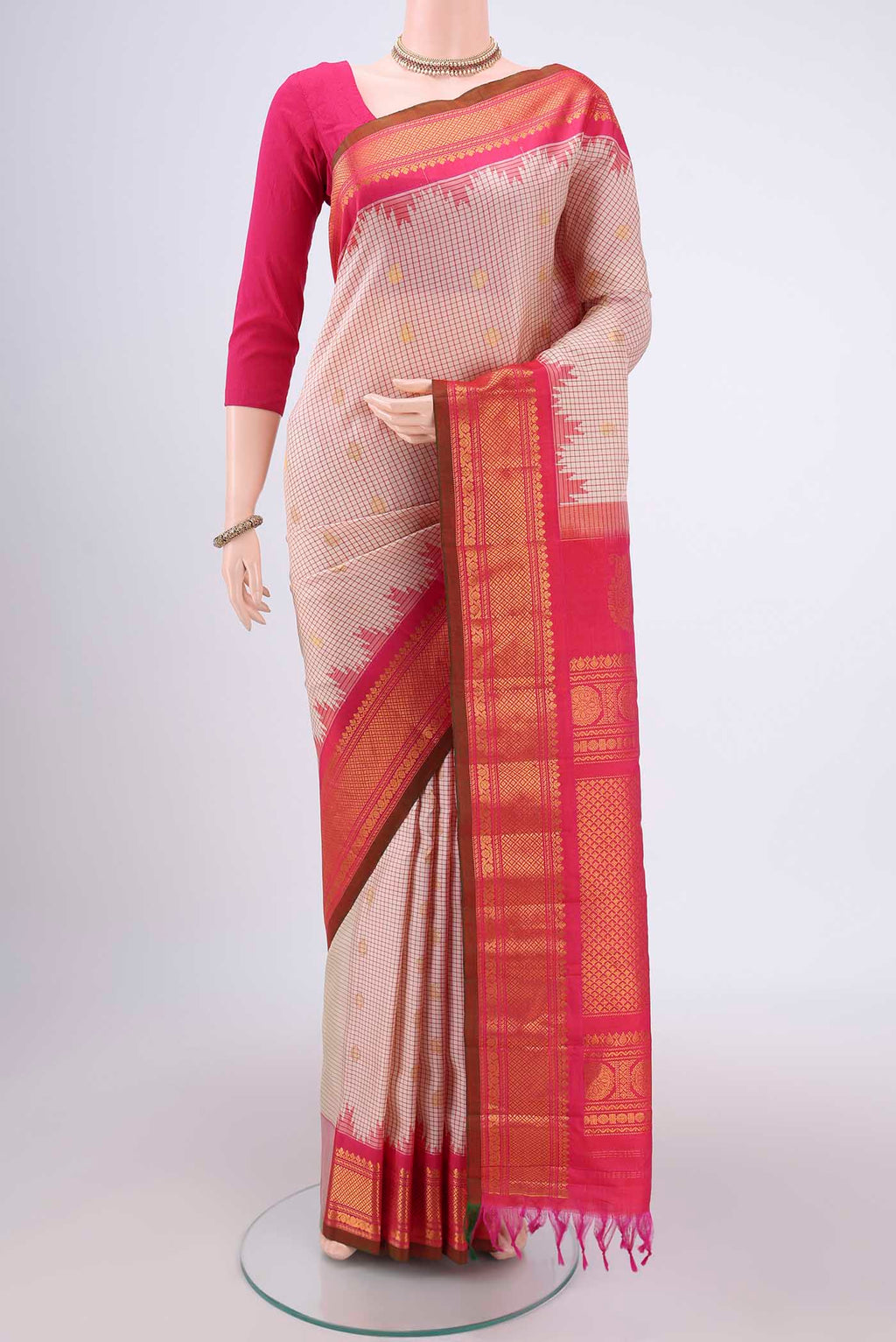 Off White Gadwal Silk Saree with Checked design on the body and Zari Border.  displayed on a mannequin