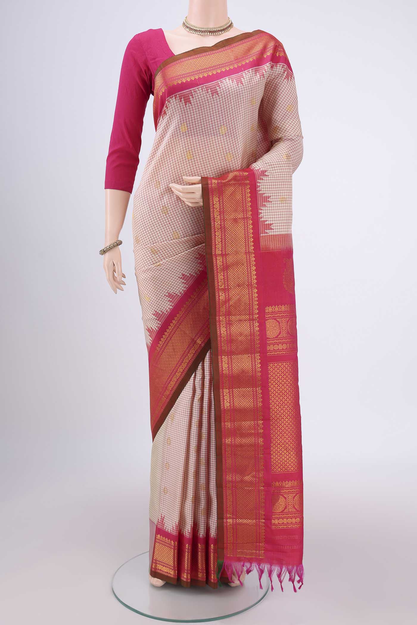 Off White Gadwal Silk Saree with Checked design on the body and Zari Border.  displayed on a mannequin