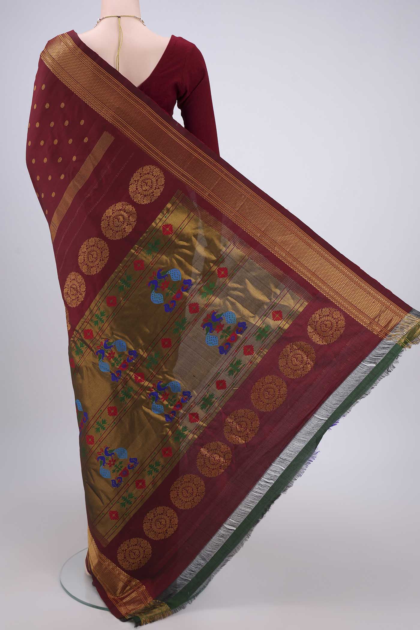Flat view of Maroon Gadwal Silk Saree with Zari Butta on the body and Zari Border. 