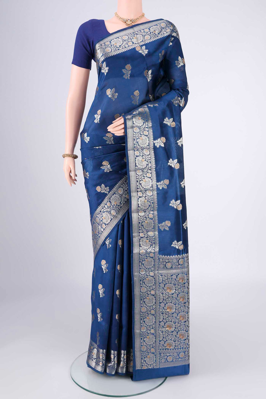 Blue Banarasi Raw Silk Saree with Zari Butta on the body and Zari Border.  displayed on a mannequin