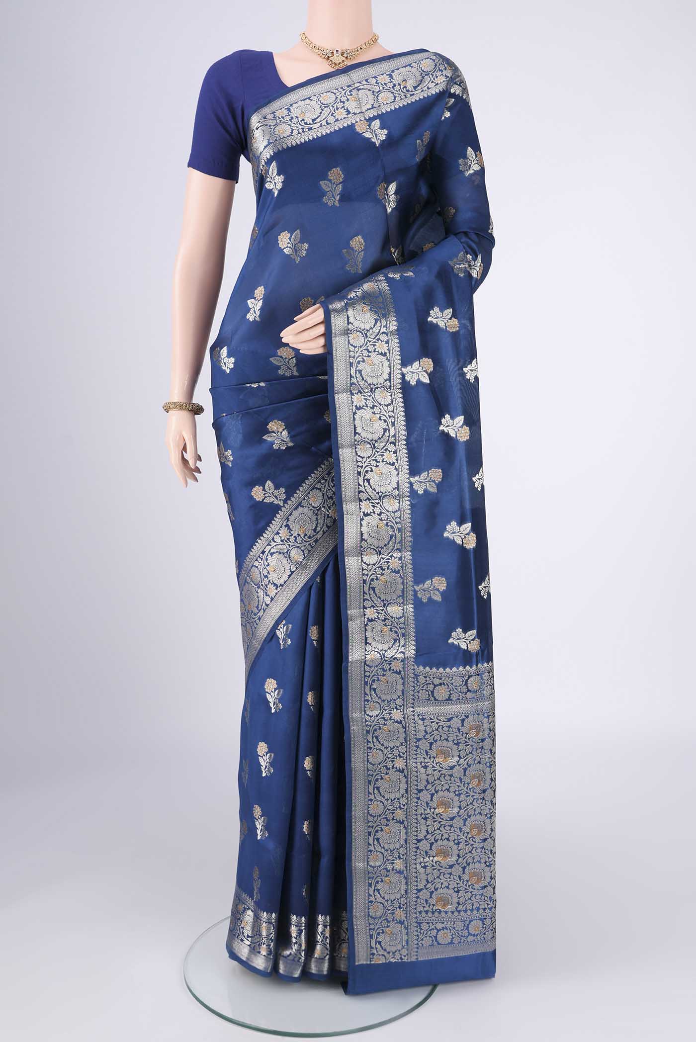 Blue Banarasi Raw Silk Saree with Zari Butta on the body and Zari Border.  displayed on a mannequin