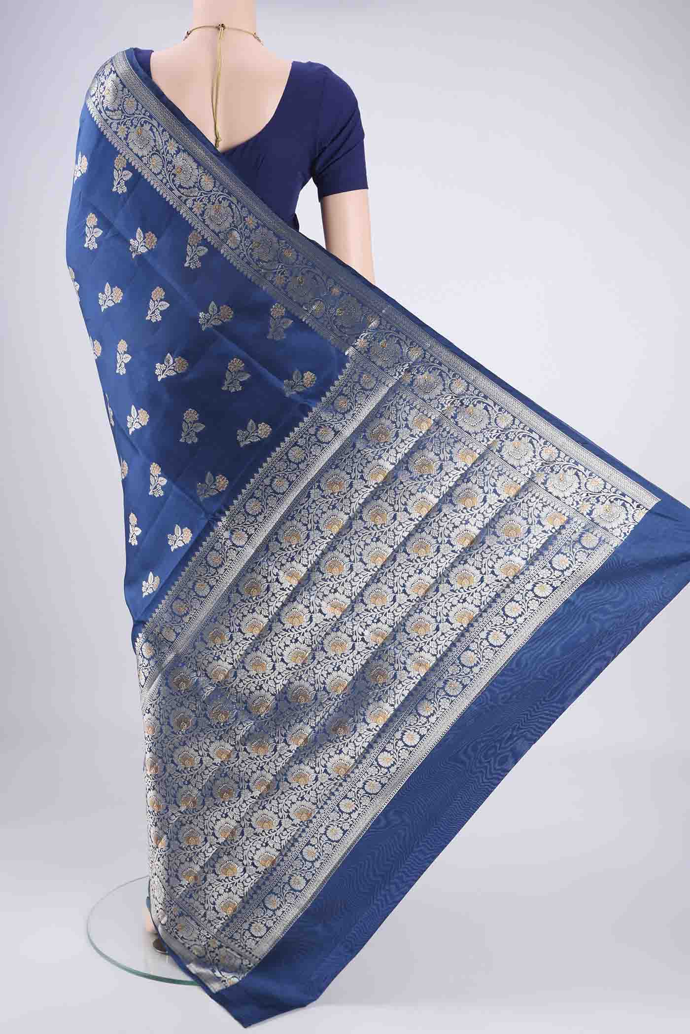 Flat view of Blue Banarasi Raw Silk Saree with Zari Butta on the body and Zari Border. 