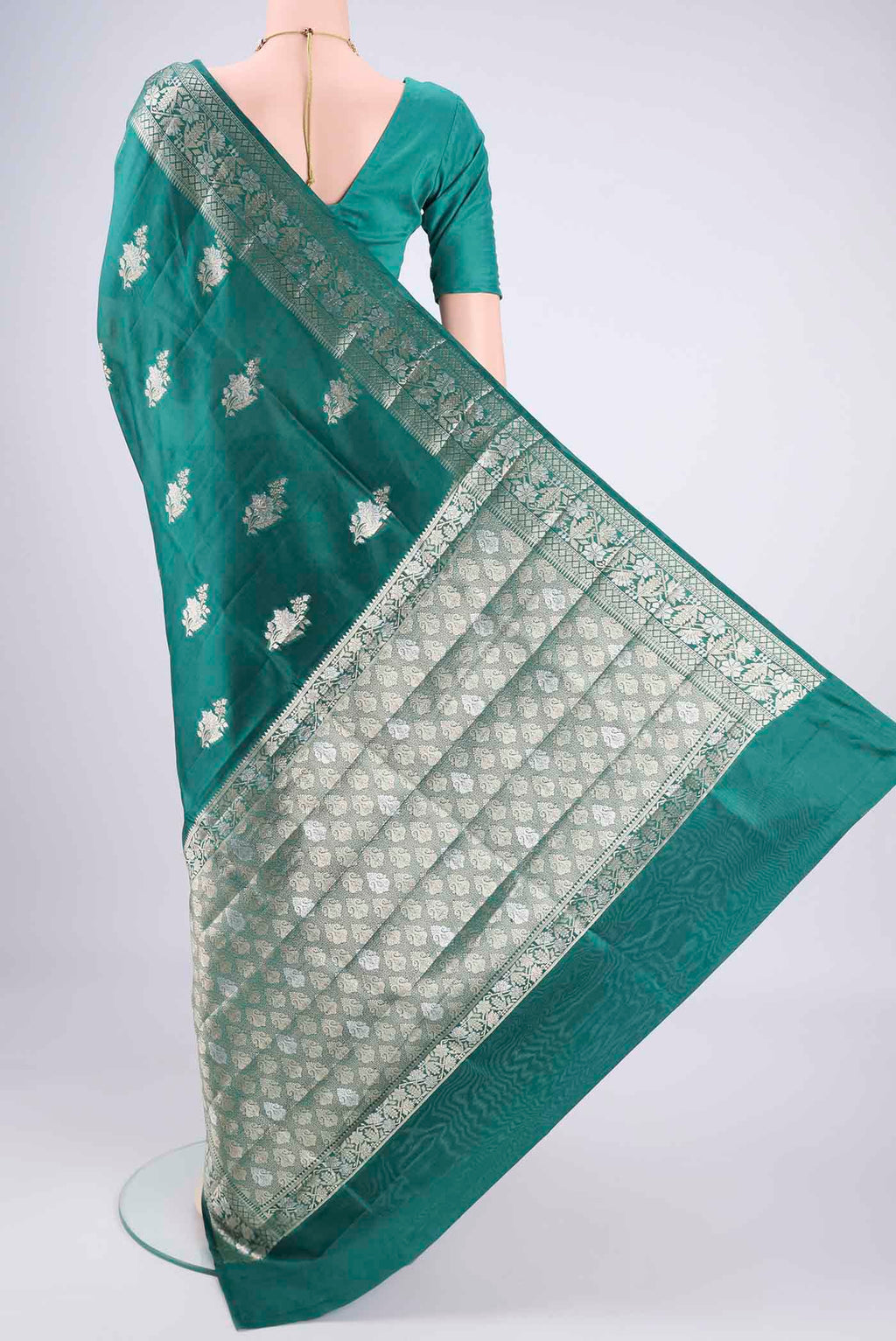 Flat view of Bottle Green Banarasi Raw Silk Saree with Zari Butta on the body and Zari Border. 