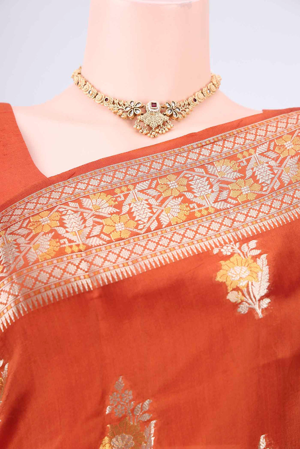 Border image of Rust Banarasi Raw Silk Saree with Zari Butta on the body and Zari Border. 