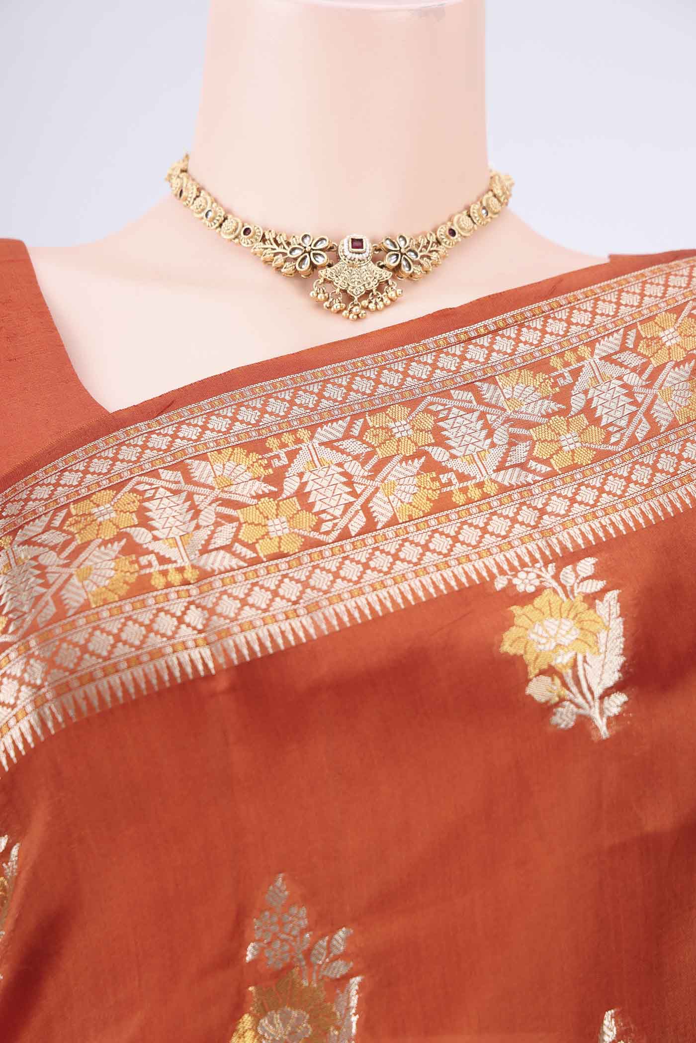 Border image of Rust Banarasi Raw Silk Saree with Zari Butta on the body and Zari Border. 