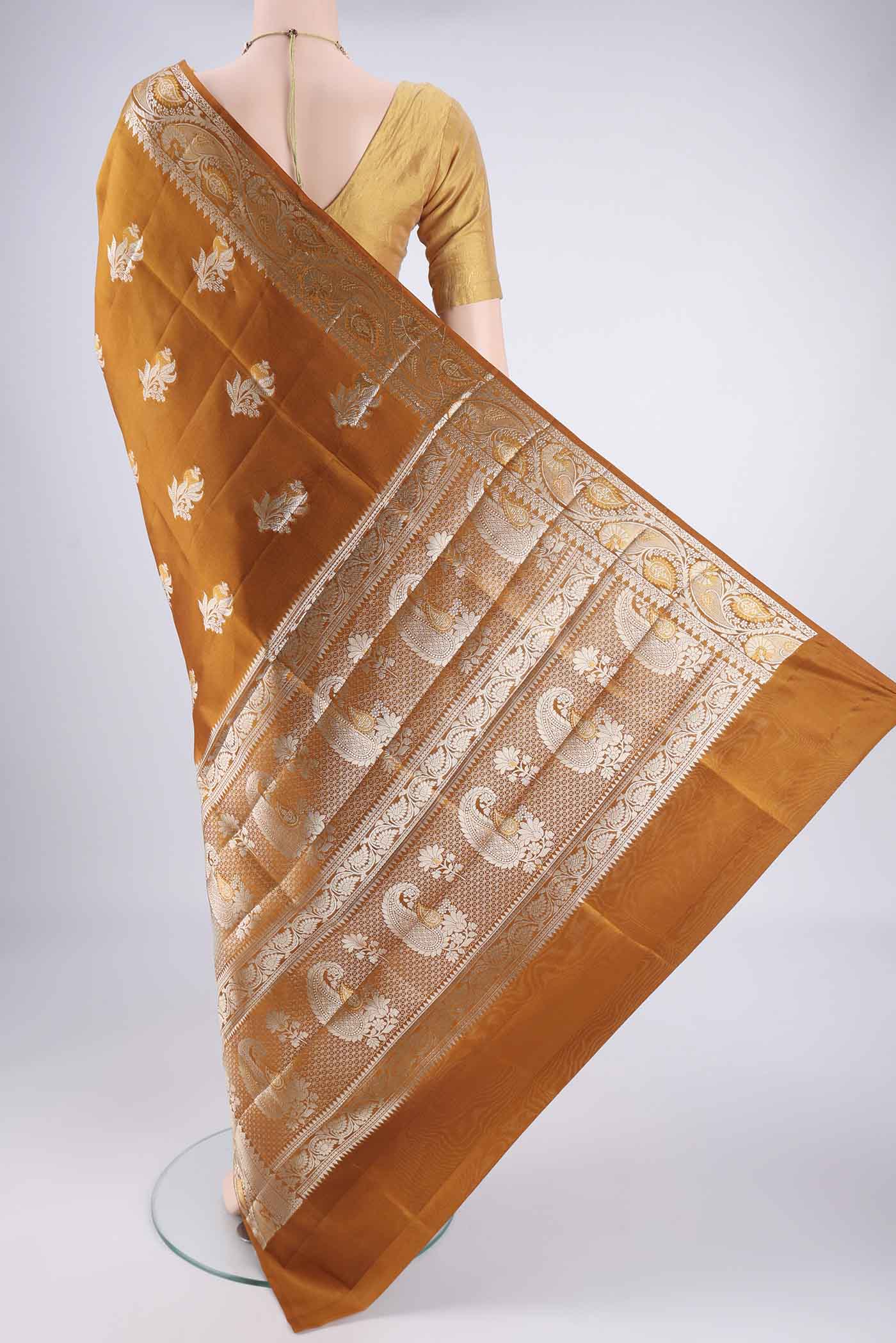 Flat view of Caramel Banarasi Raw Silk Saree with Zari Butta on the body and Zari Border. 