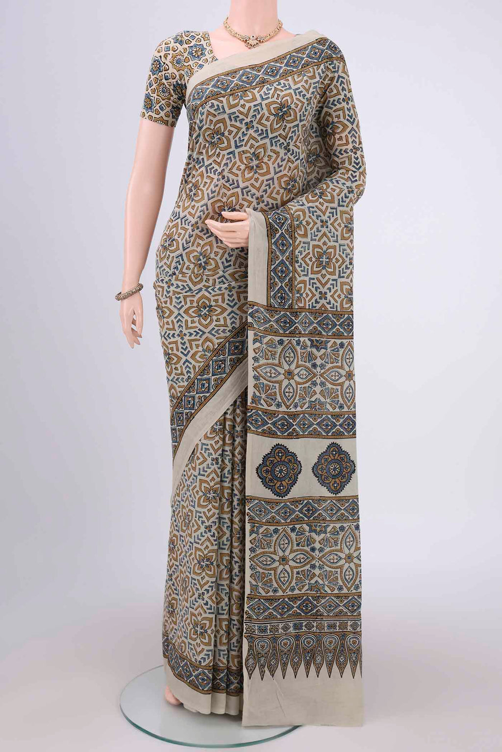 Beige Maheshwari Silk Cotton Saree with Ajrakh Print on the body and Plain Border.  displayed on a mannequin