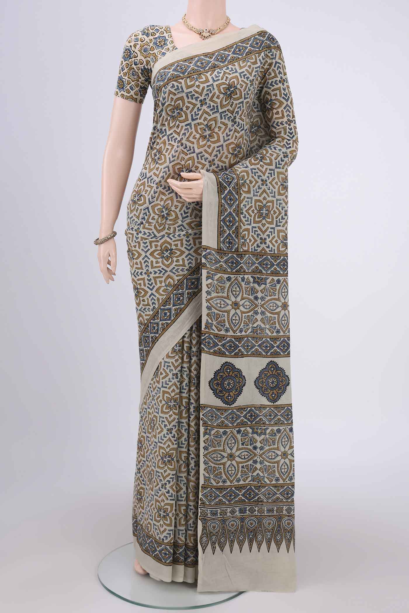 Beige Maheshwari Silk Cotton Saree with Ajrakh Print on the body and Plain Border.  displayed on a mannequin