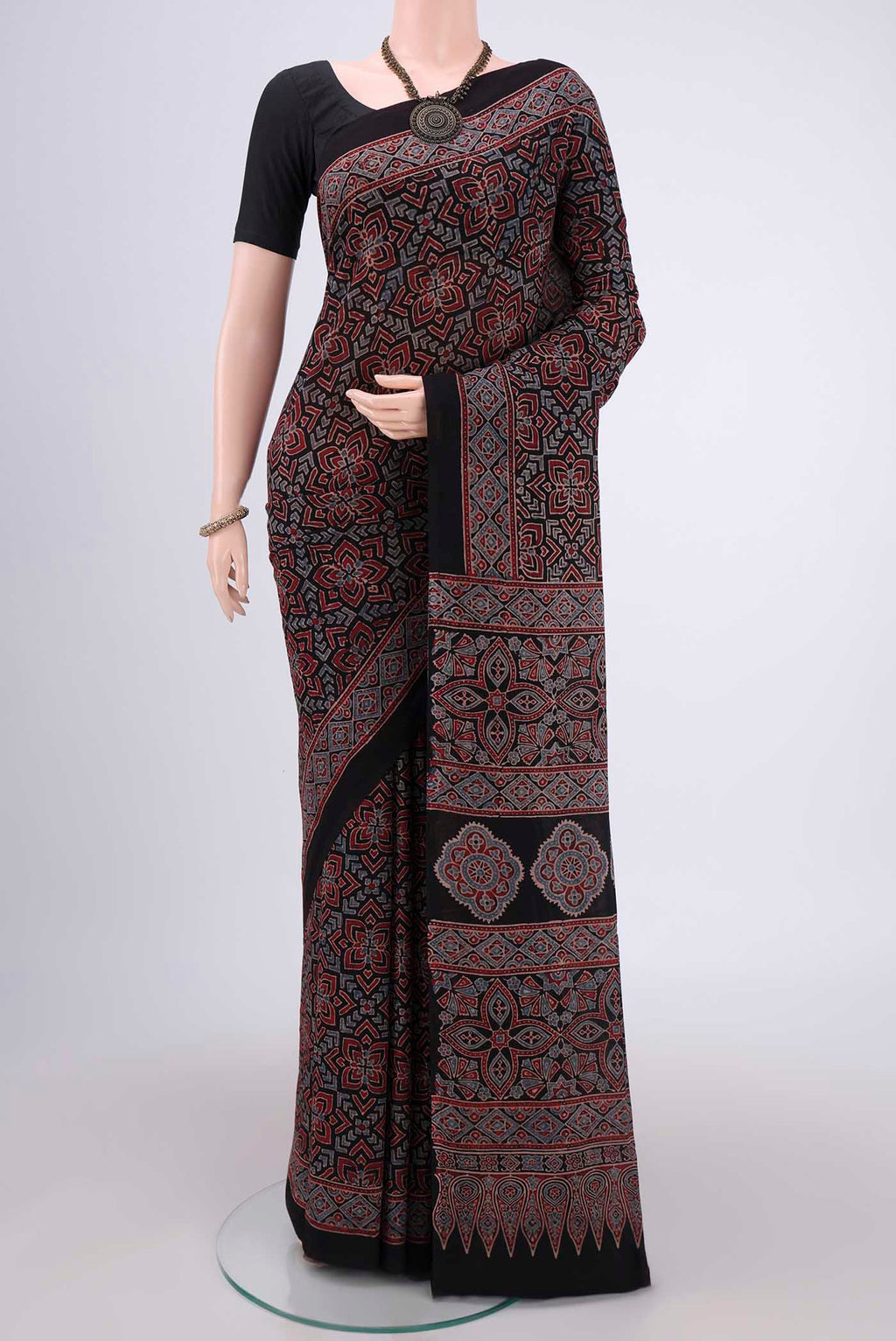 Black Maheshwari Silk Cotton Saree with Ajrakh Print on the body and Plain Border.  displayed on a mannequin