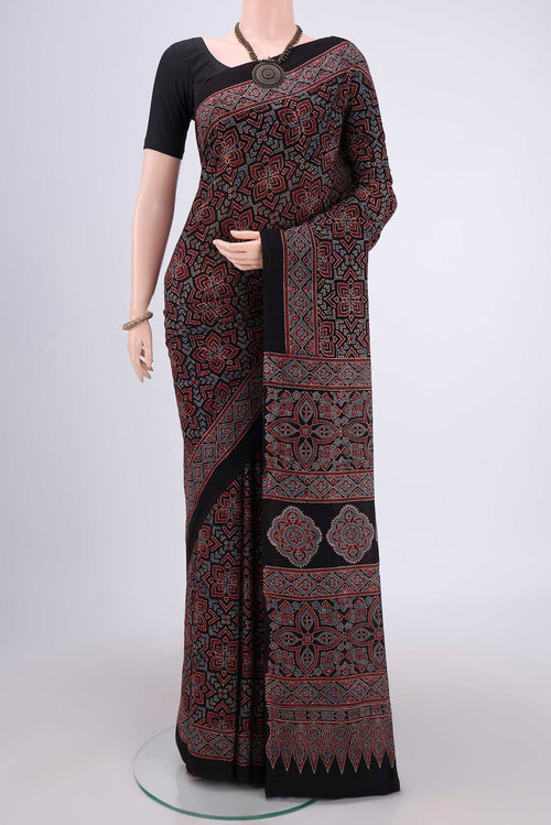 Black Maheshwari Silk Cotton Saree with Ajrakh Print on the body and Plain Border.  displayed on a mannequin