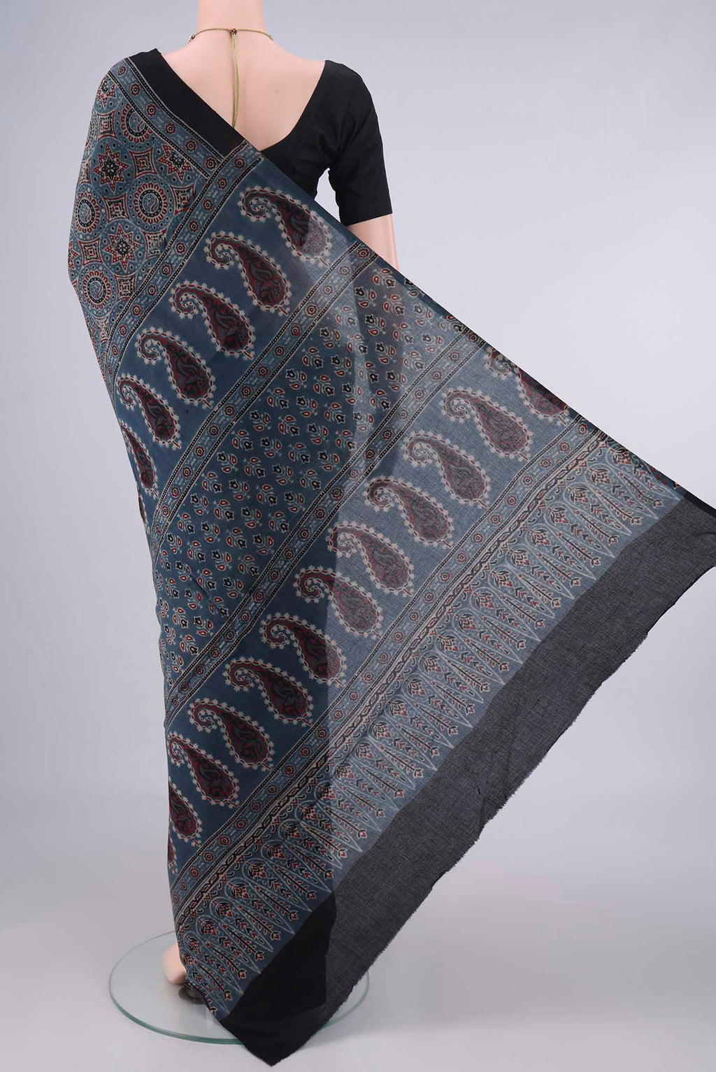 Flat view of Indigo Cotton Saree with Ajrakh Print on the body and Printed Border. 