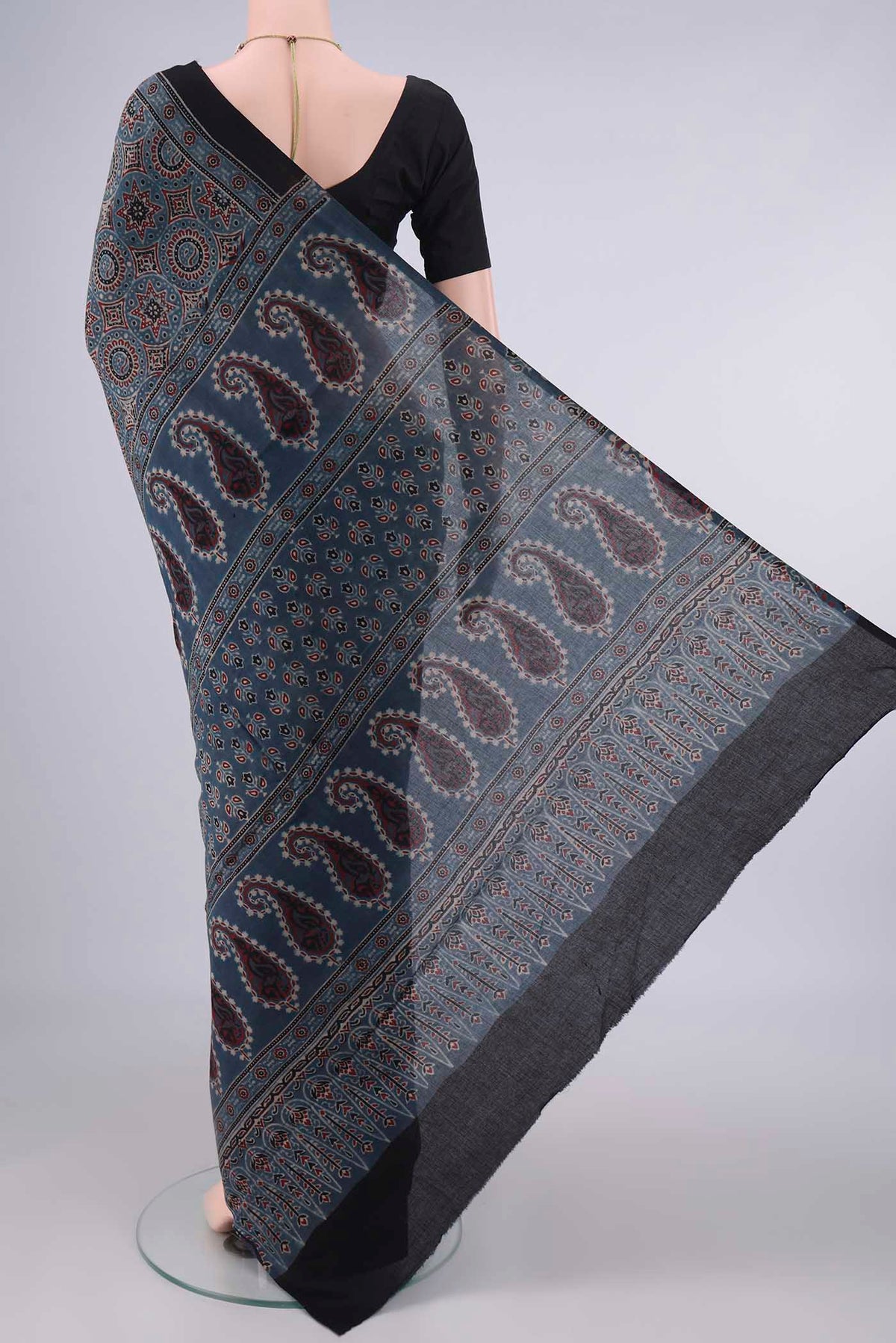 Flat view of Indigo Cotton Saree with Ajrakh Print on the body and Printed Border. 
