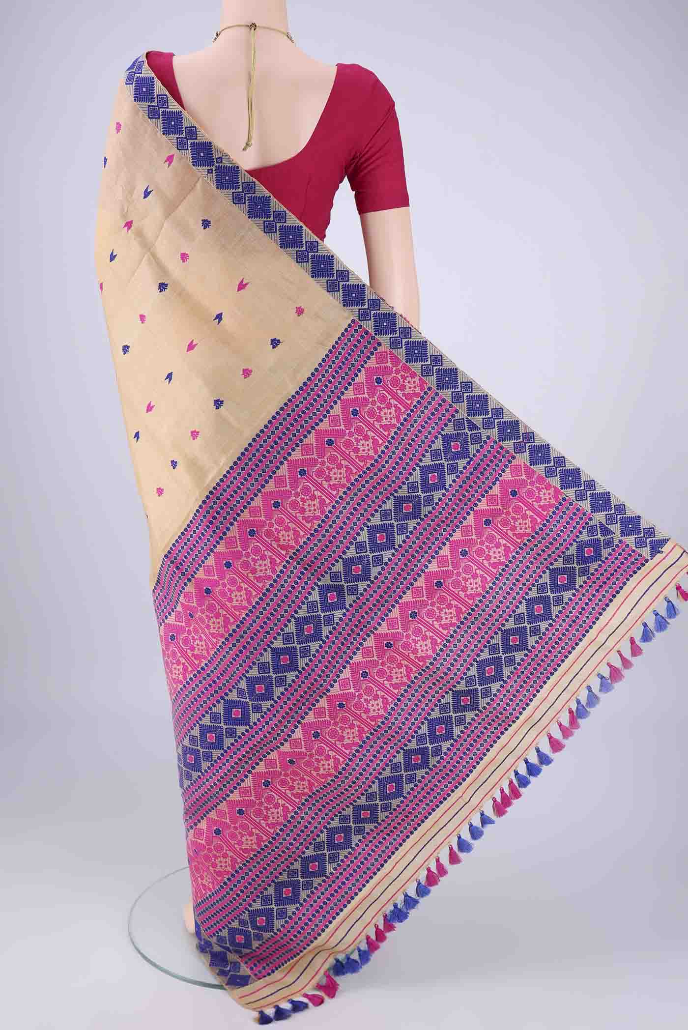 Flat view of Beige Assam Silk Saree with Thread Butta on the body and Thread Border. 