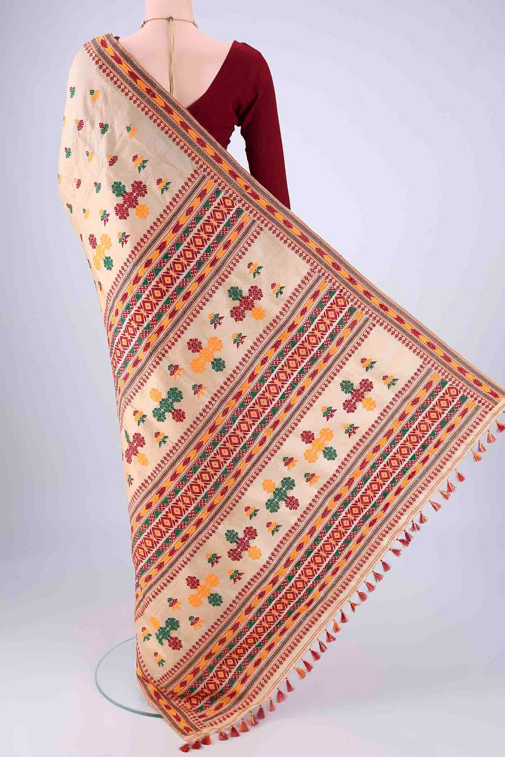 Flat view of Beige Assam Silk Saree with Thread Butta on the body and Thread Border. 