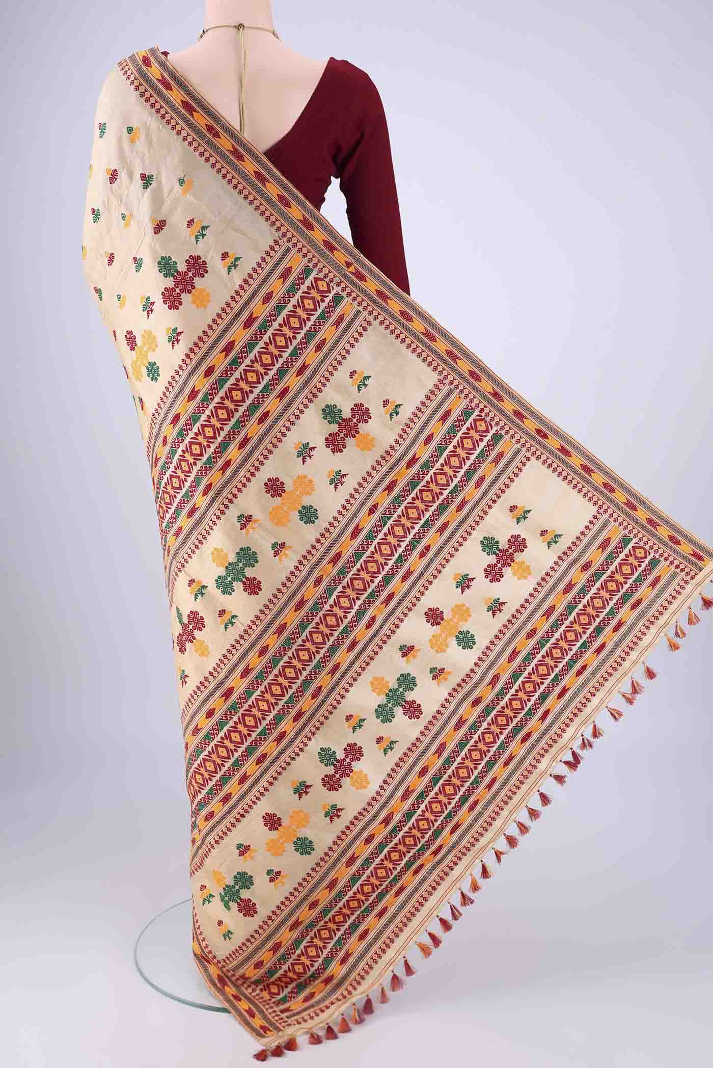 Flat view of Beige Assam Silk Saree with Thread Butta on the body and Thread Border. 