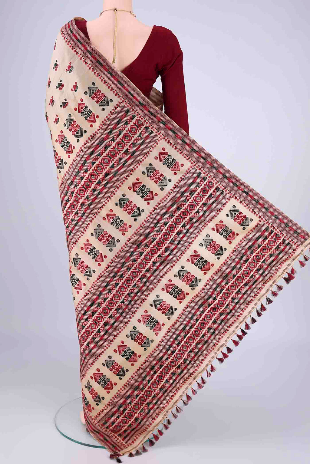 Flat view of Beige Assam Silk Saree with Thread Butta on the body and Thread Border. 