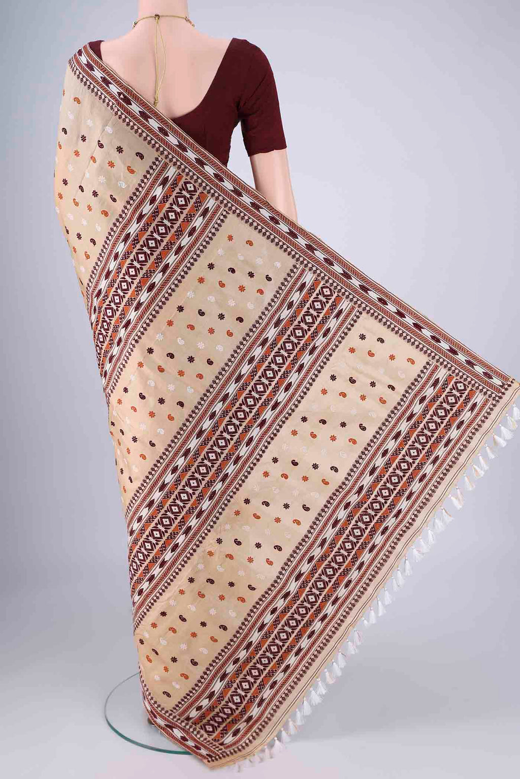Flat view of Beige Assam Silk Saree with Thread Butta on the body and Thread Border. 