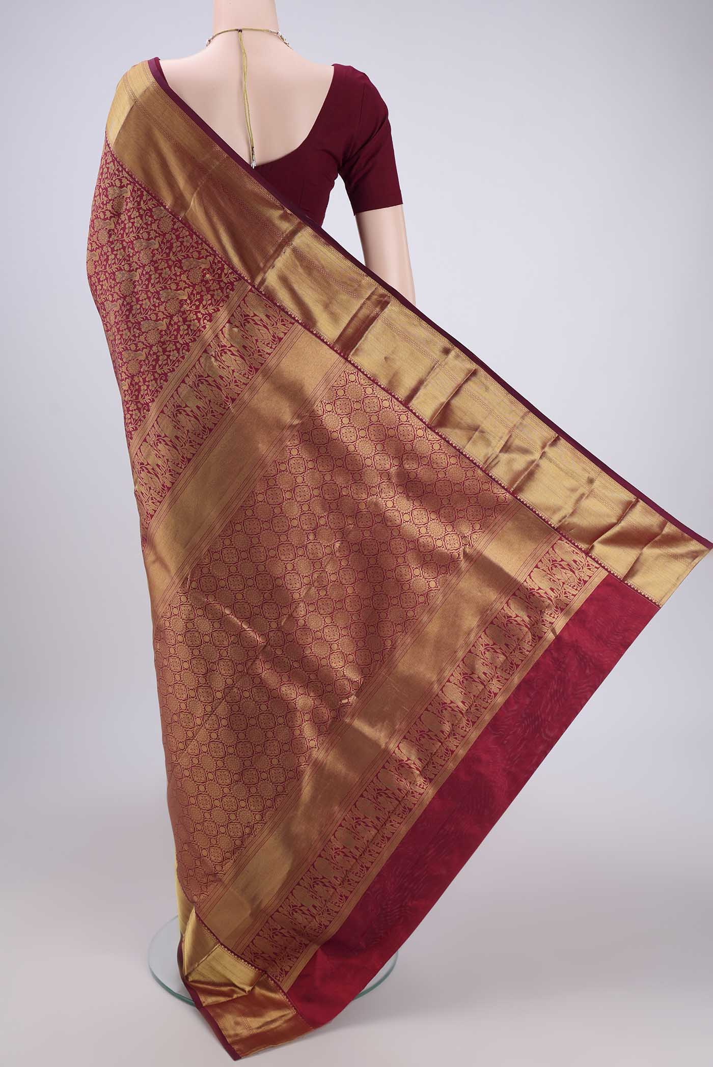 Flat view of Maroon Bangalore Silk Saree with Zari Brocade on the body and Zari Border. 