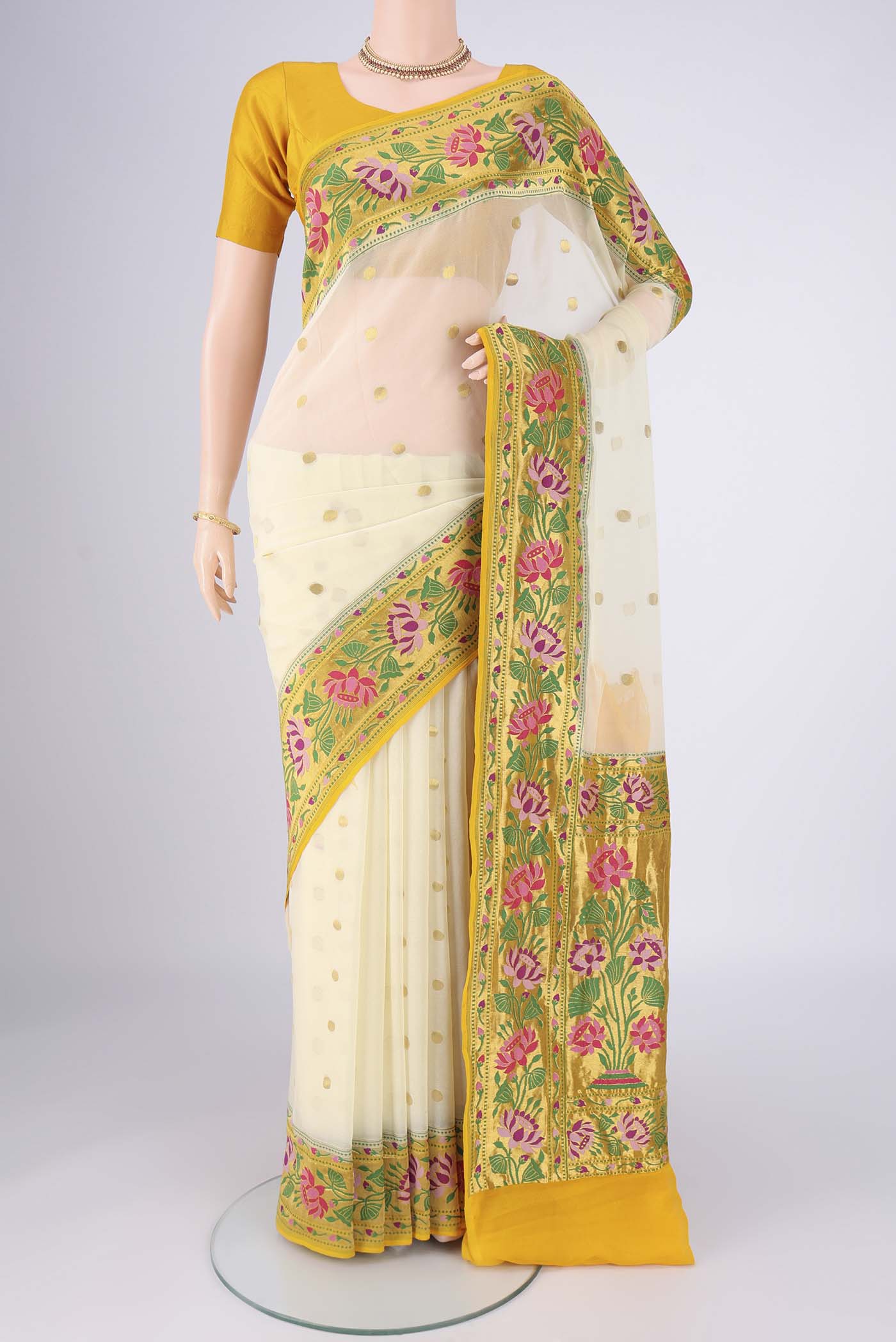 Cream Banarasi Georgette Saree with Zari Butta on the body and Zari Border.  displayed on a mannequin