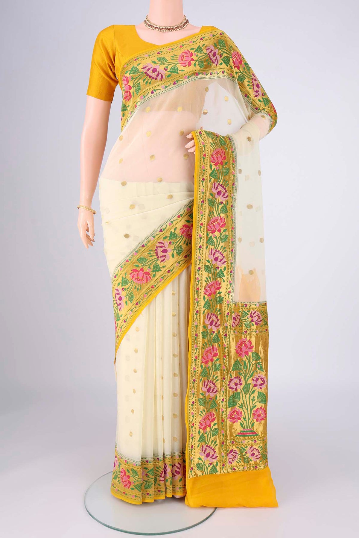 Cream Banarasi Georgette Saree with Zari Butta on the body and Zari Border.  displayed on a mannequin
