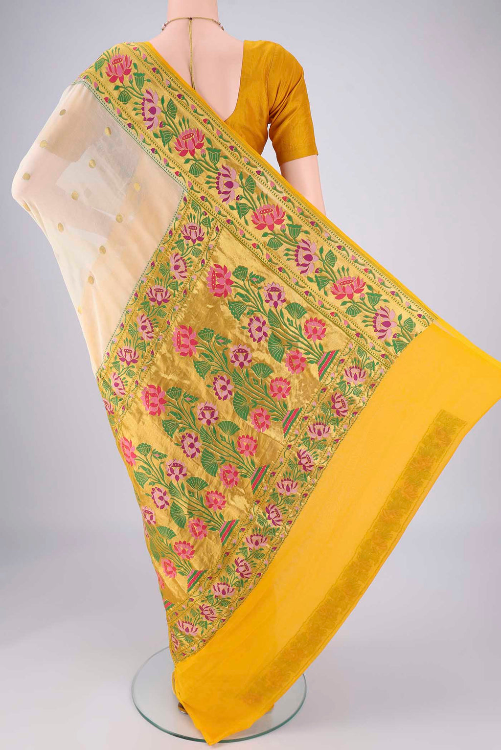 Flat view of Cream Banarasi Georgette Saree with Zari Butta on the body and Zari Border. 