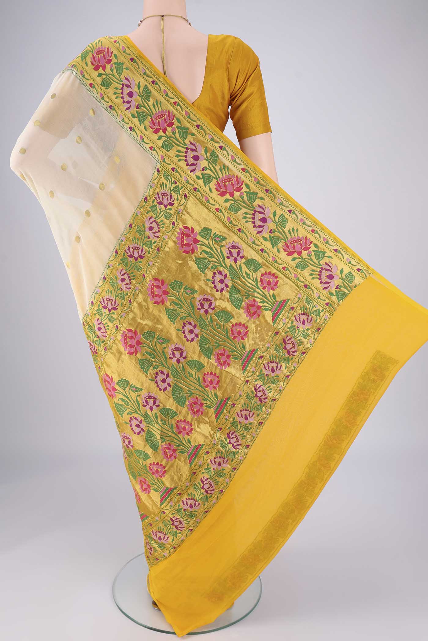 Flat view of Cream Banarasi Georgette Saree with Zari Butta on the body and Zari Border. 