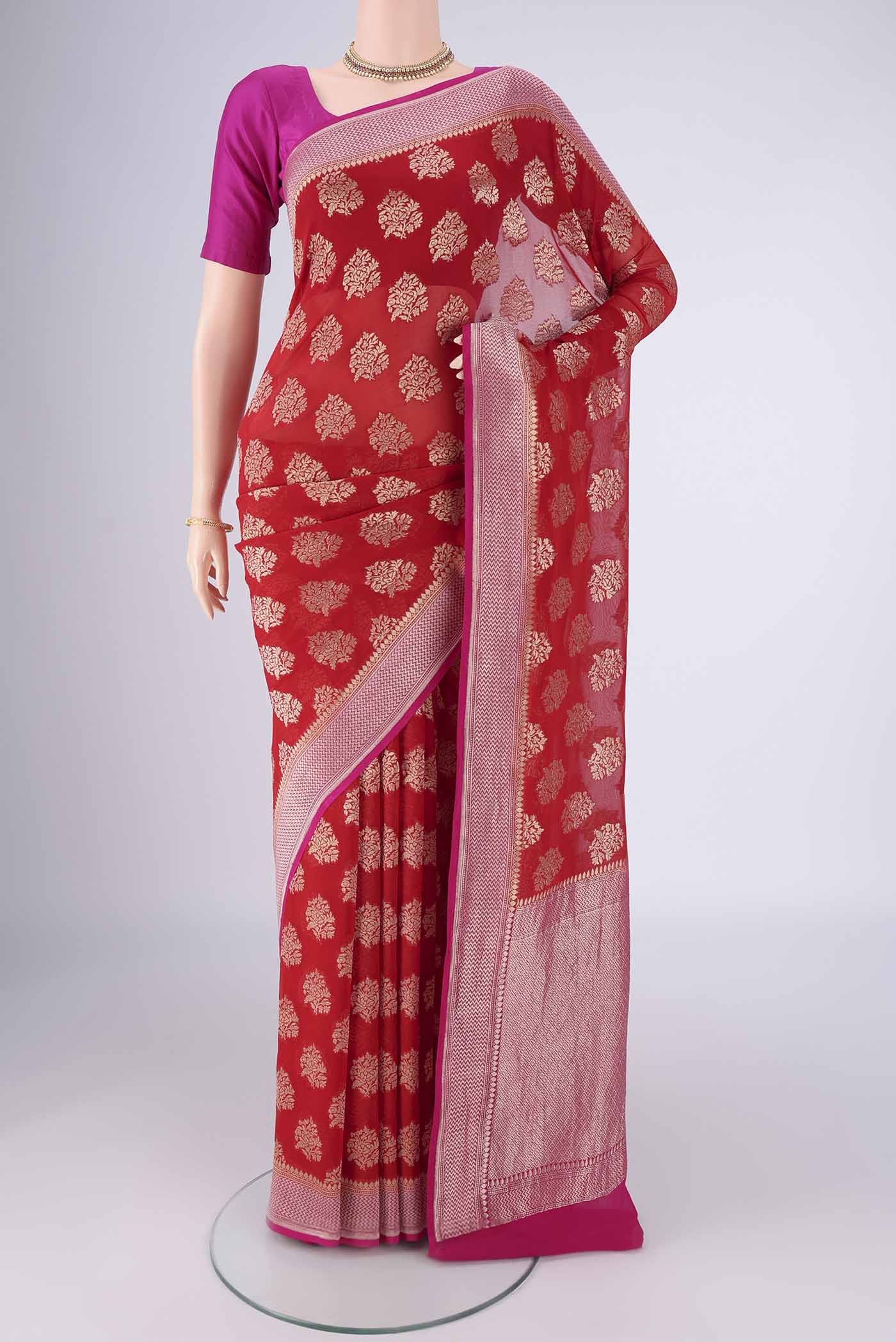 Red Banarasi Georgette Saree with Zari Brocade on the body and Zari Border.  displayed on a mannequin