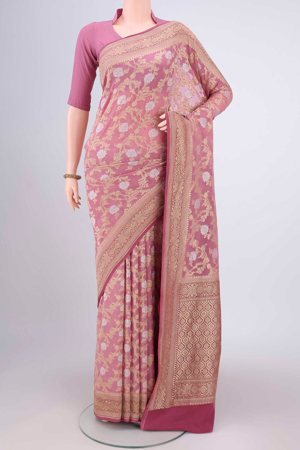 Rose Gold Banarasi Georgette Saree with Zari Brocade on the body and Zari Border.  displayed on a mannequin