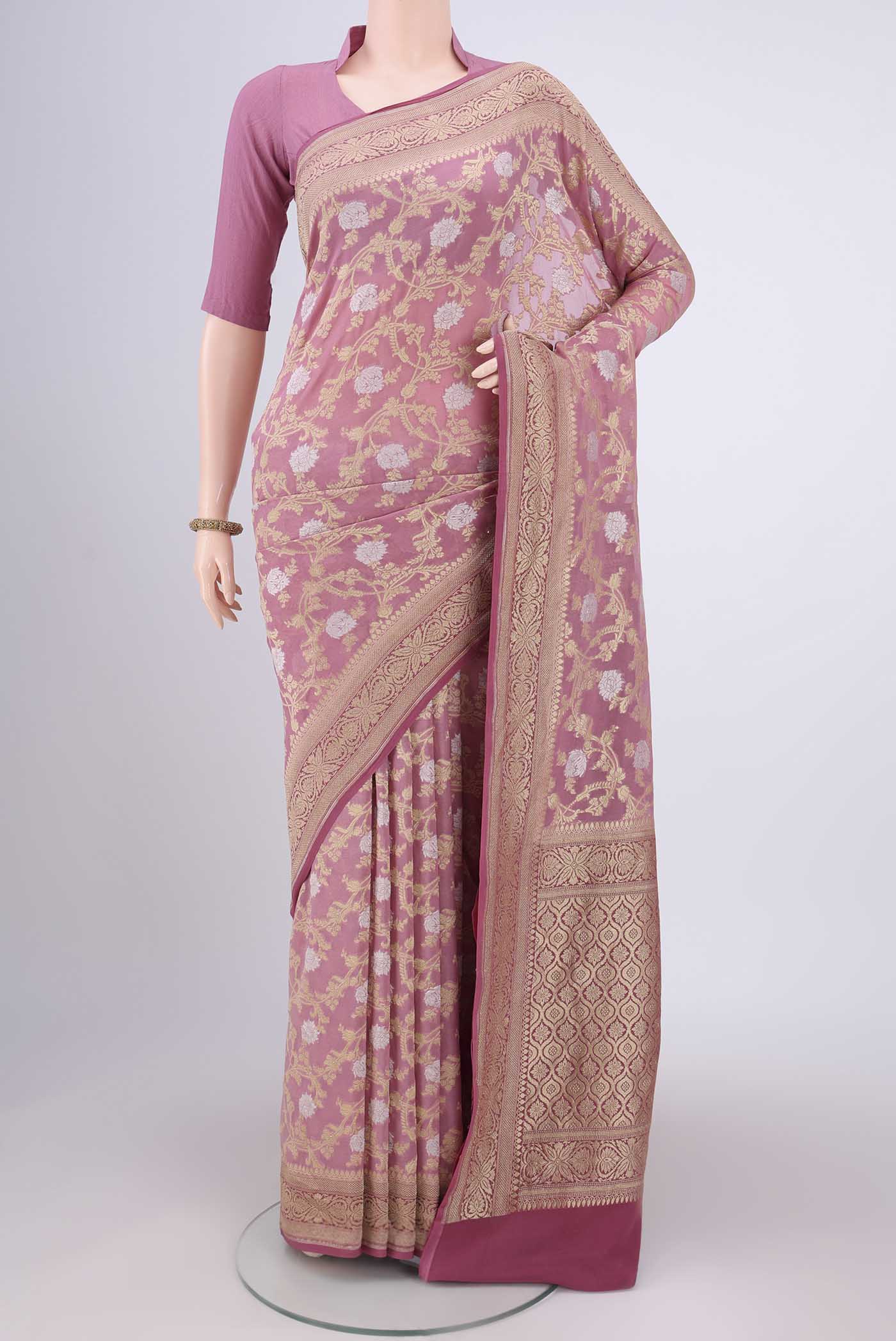 Rose Gold Banarasi Georgette Saree with Zari Brocade on the body and Zari Border.  displayed on a mannequin