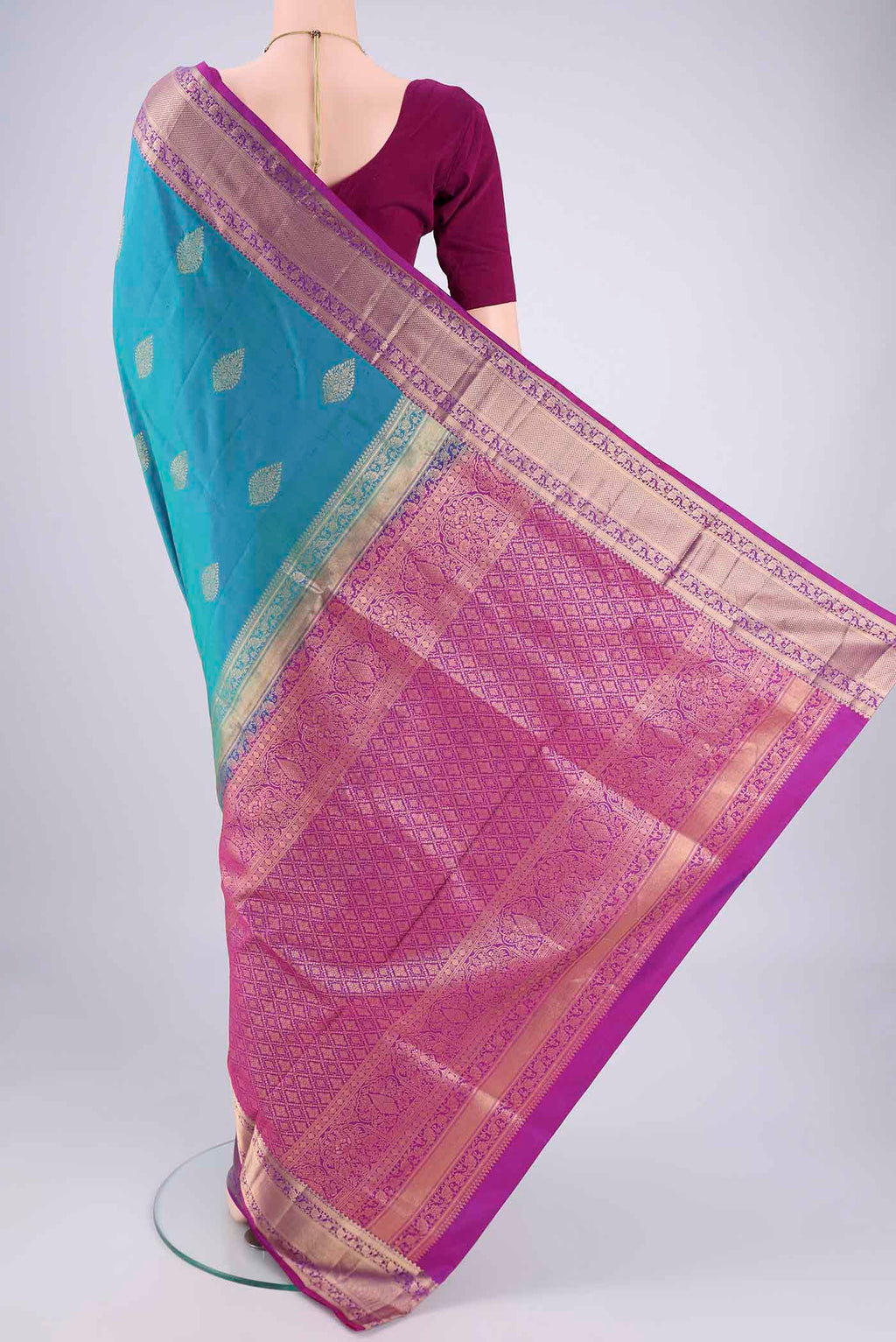 Flat view of Blue Dual Tone Soft Silk Saree with Zari Butta on the body and Zari Border. 