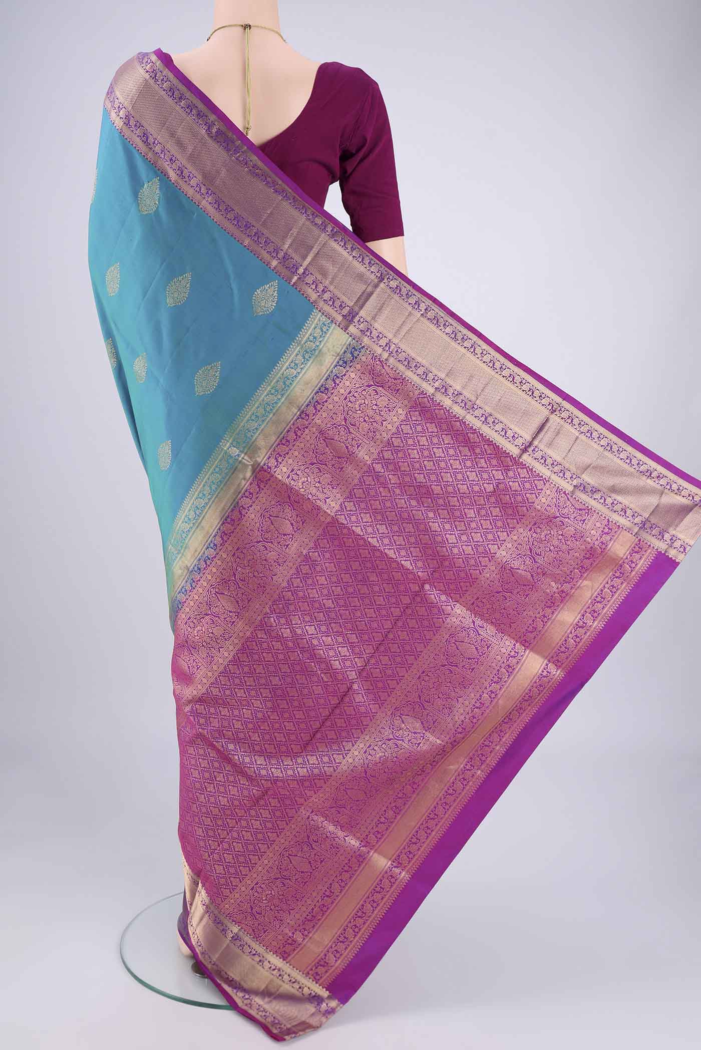 Flat view of Blue Dual Tone Soft Silk Saree with Zari Butta on the body and Zari Border. 