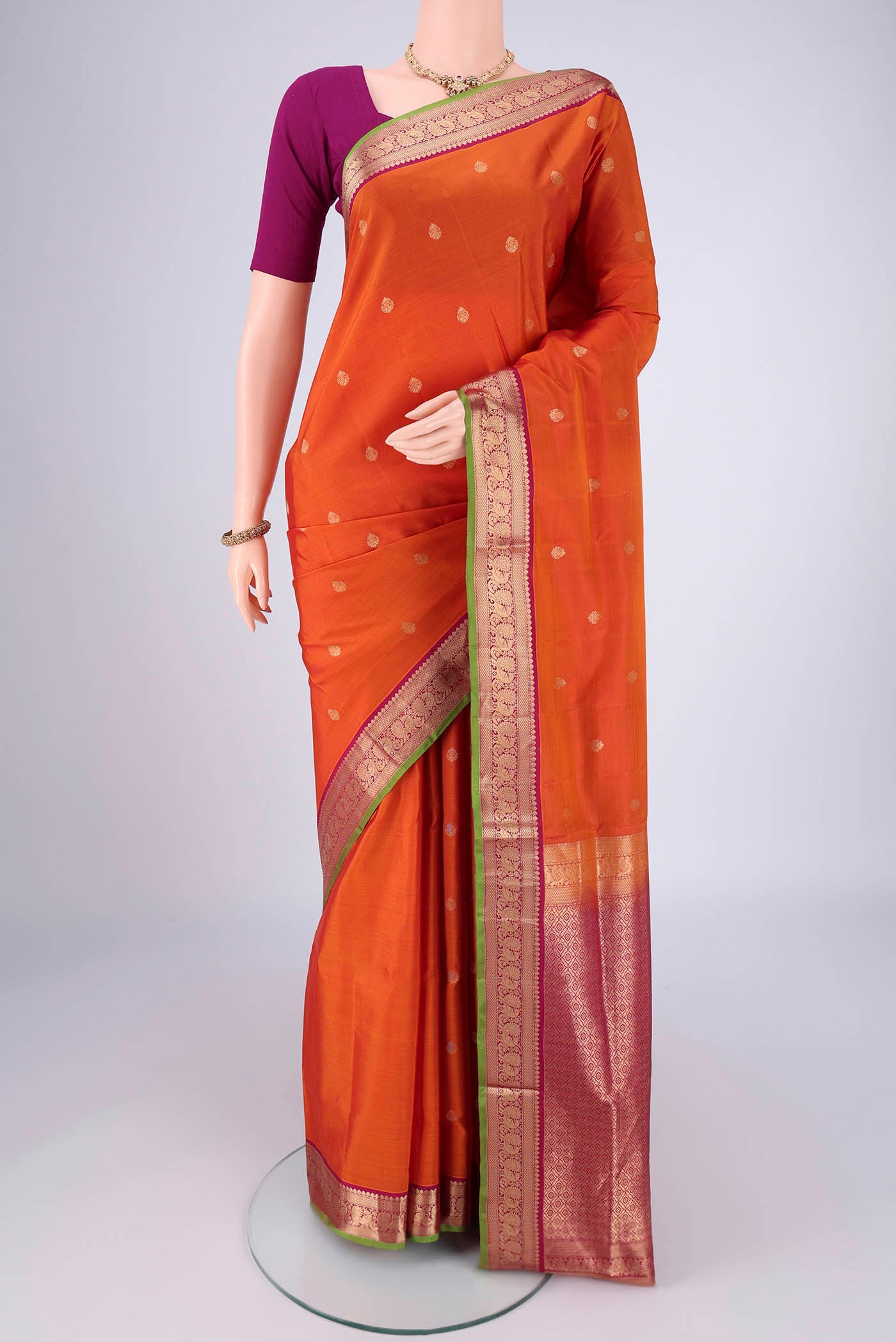 Rust Dual Tone Soft Silk Saree with Zari Brocade on the body and Zari Border.  displayed on a mannequin