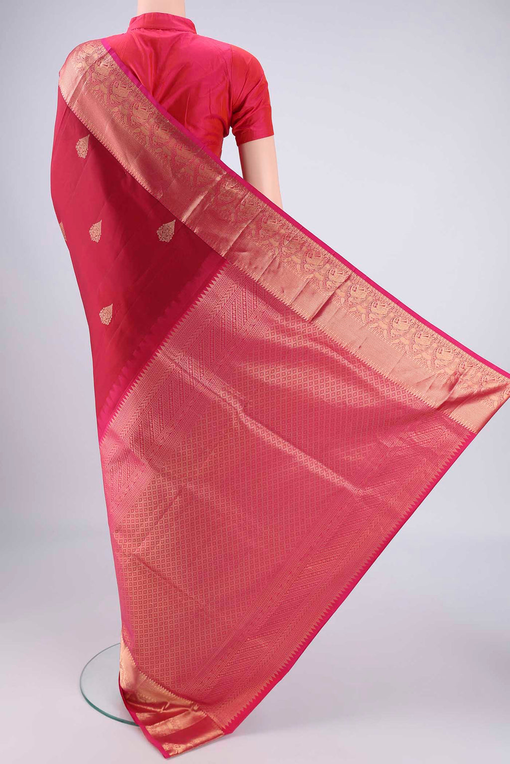 Flat view of Maroon Soft Silk Saree with Zari Butta on the body and Zari Border. 