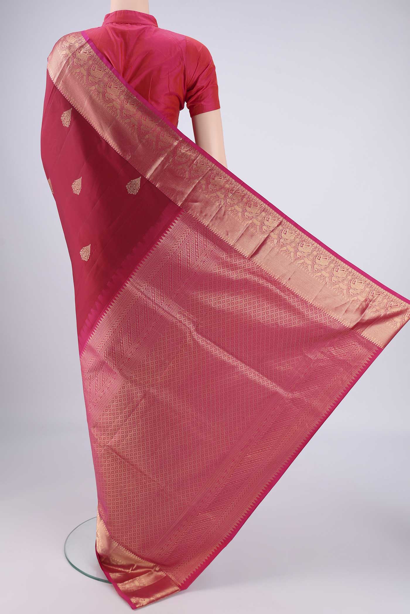 Flat view of Maroon Soft Silk Saree with Zari Butta on the body and Zari Border. 