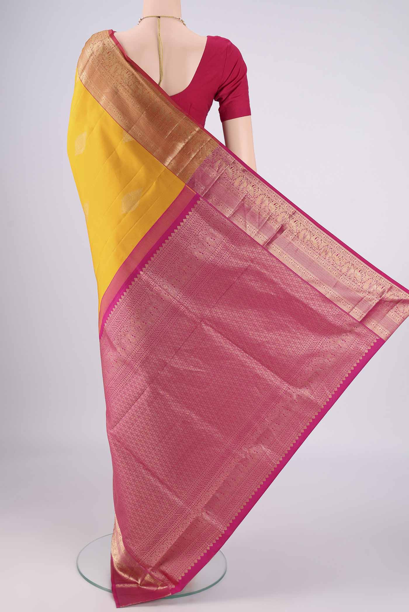 Flat view of Yellow Soft Silk Saree with Zari Butta on the body and Zari Border. 