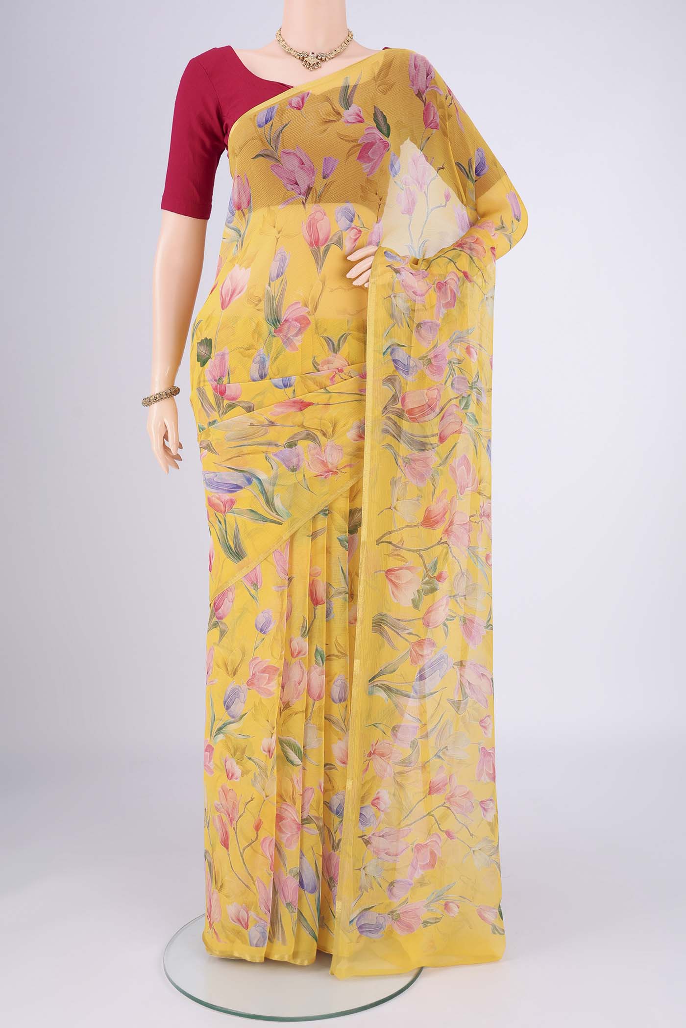 Yellow Mysore Chiffon Saree with Floral Print on the body and Thin Zari Line.  displayed on a mannequin