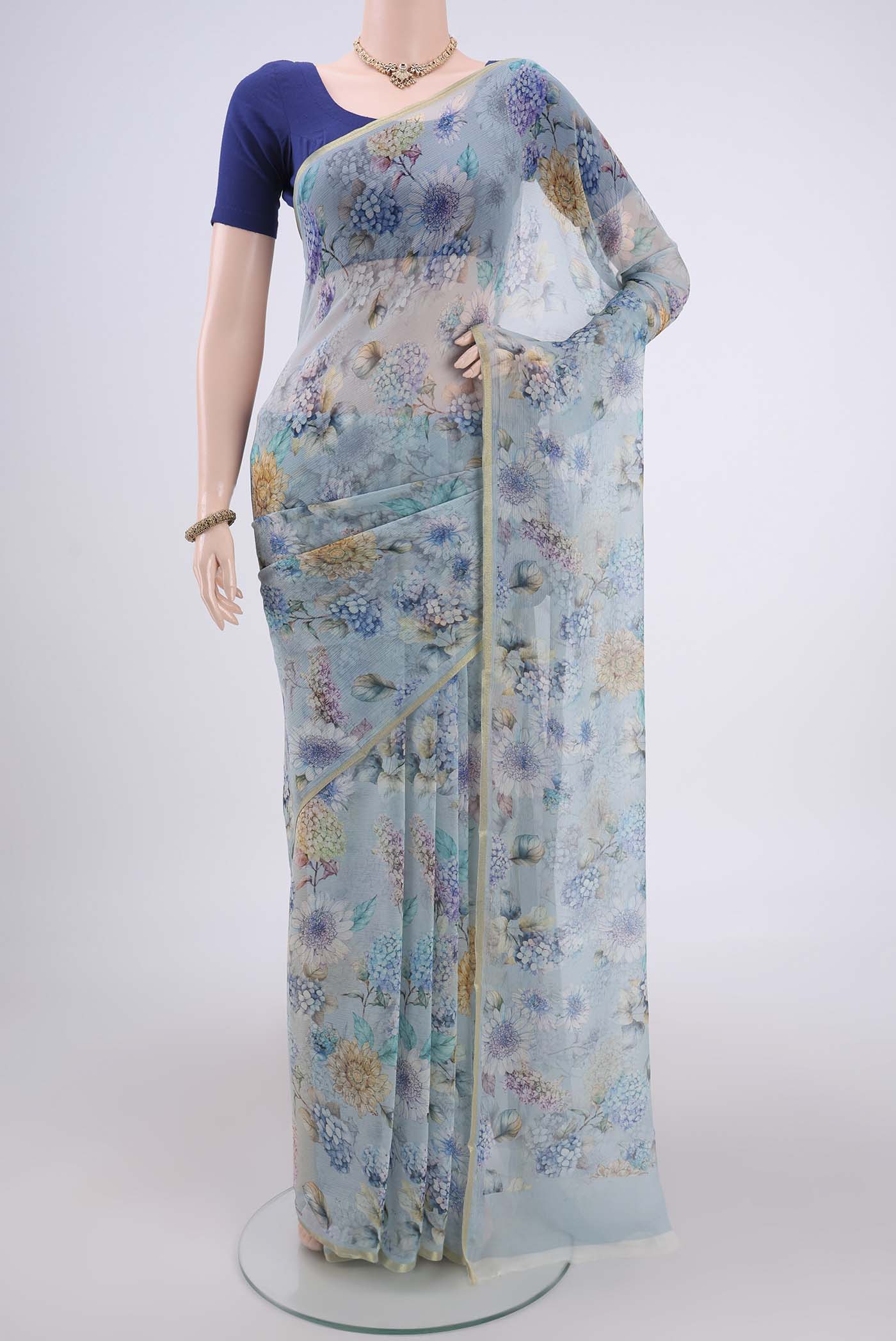 Sky Blue Mysore Chiffon Saree with Floral Print on the body and Thin Zari Line.  displayed on a mannequin