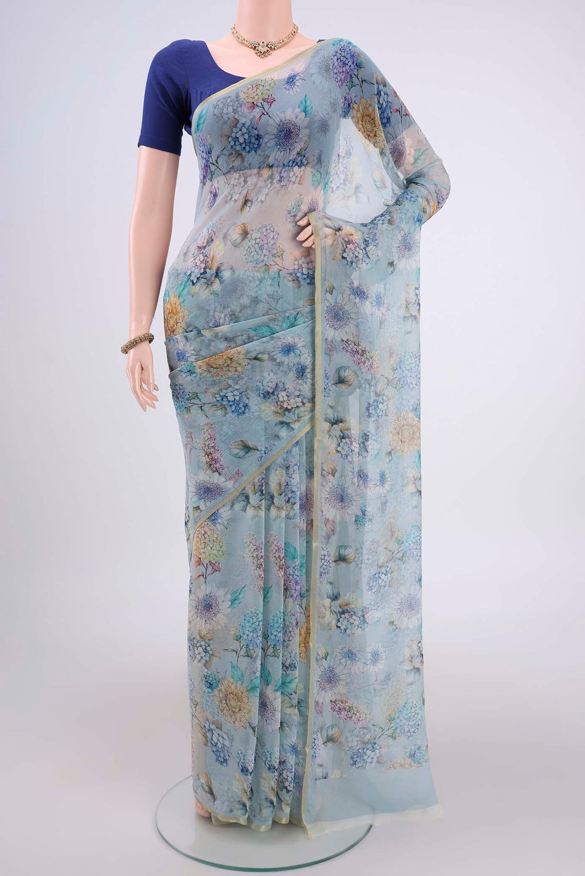 Sky Blue Mysore Chiffon Saree with Floral Print on the body and Thin Zari Line.  displayed on a mannequin