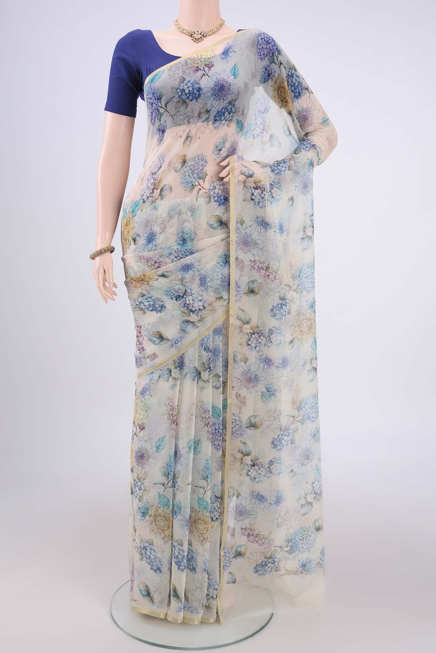 Off White Mysore Chiffon Saree with Floral Print on the body and Thin Zari Line.  displayed on a mannequin