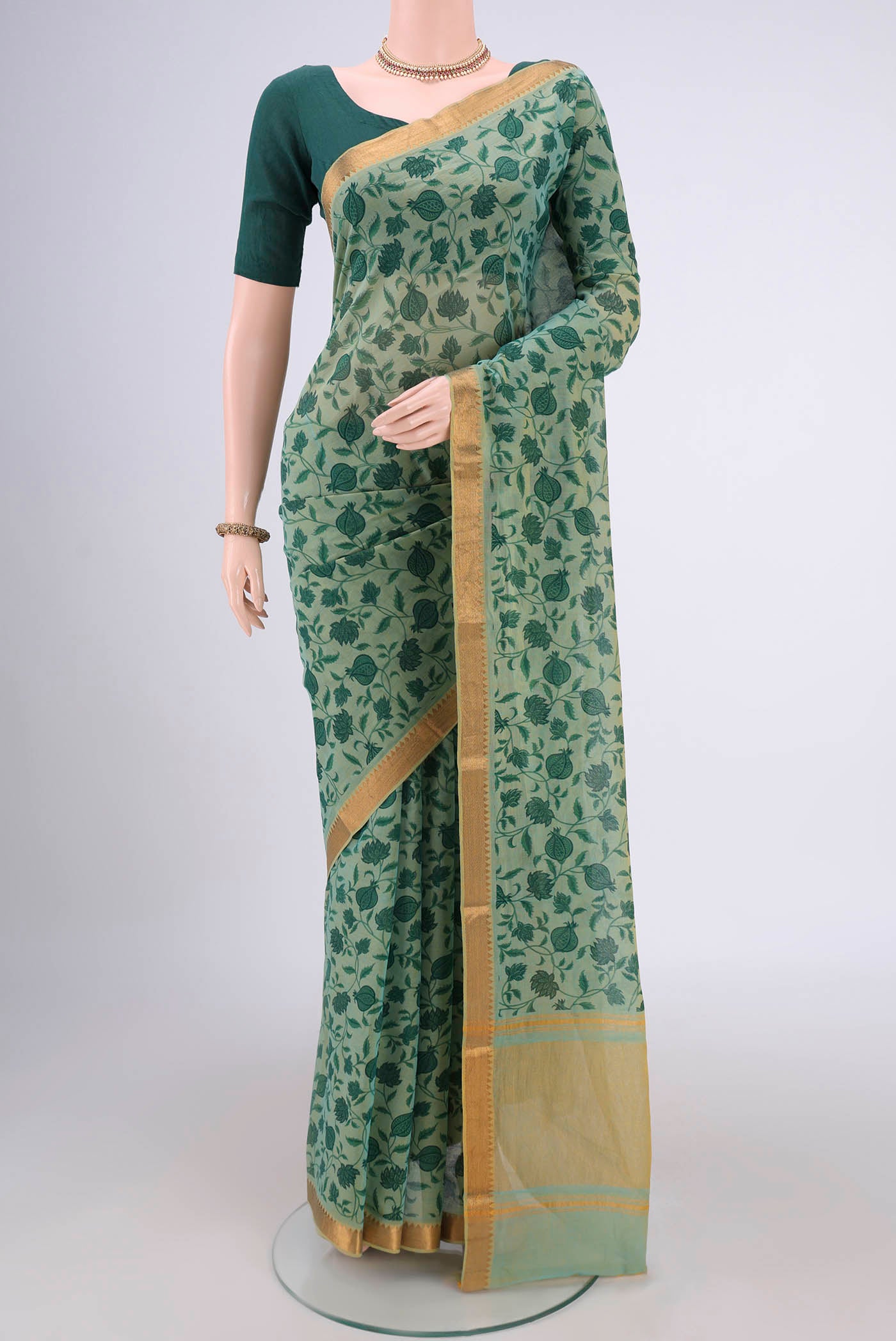 Green Mangalagiri Cotton Saree with Printed design on the body and Zari Border.  displayed on a mannequin