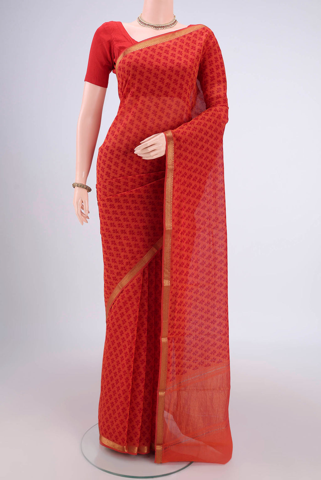 Saffron Mangalagiri Cotton Saree with Printed design on the body and Zari Border.  displayed on a mannequin