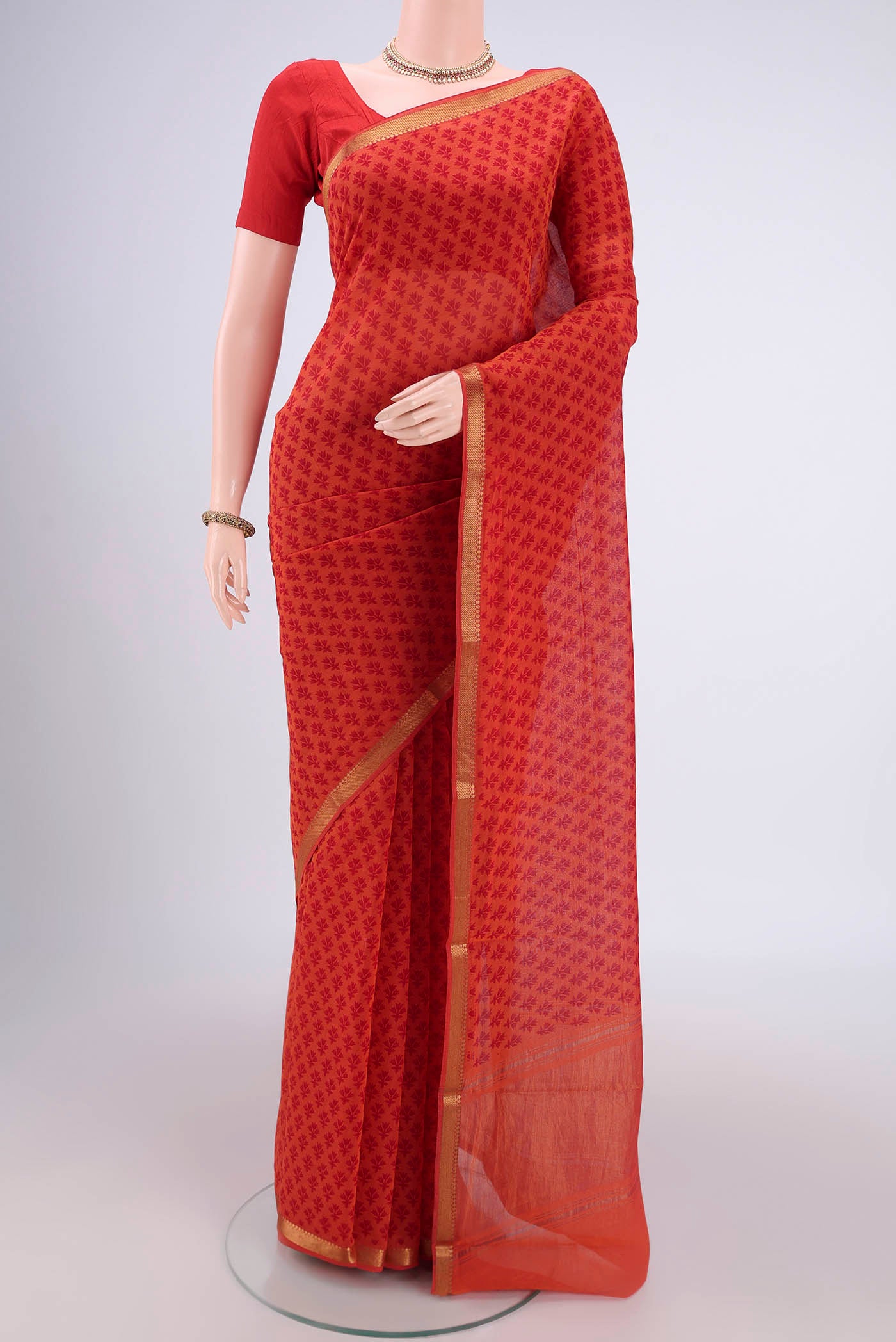 Saffron Mangalagiri Cotton Saree with Printed design on the body and Zari Border.  displayed on a mannequin