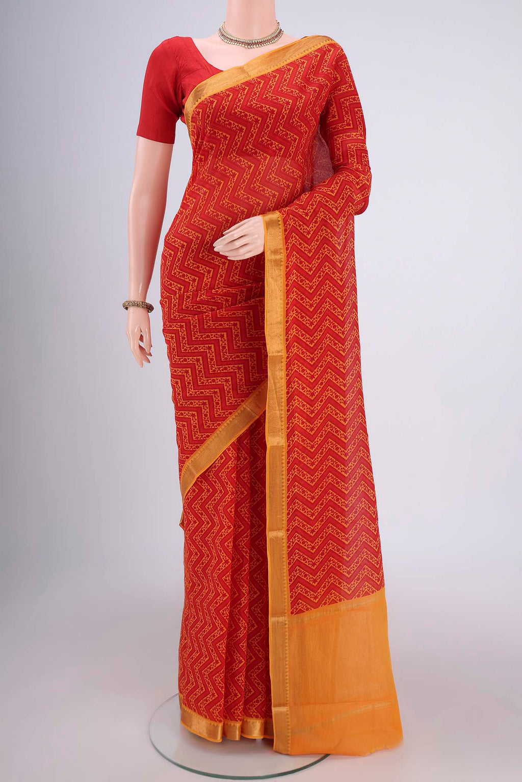 Red Mangalagiri Cotton Saree with Printed design on the body and Zari Border.  displayed on a mannequin