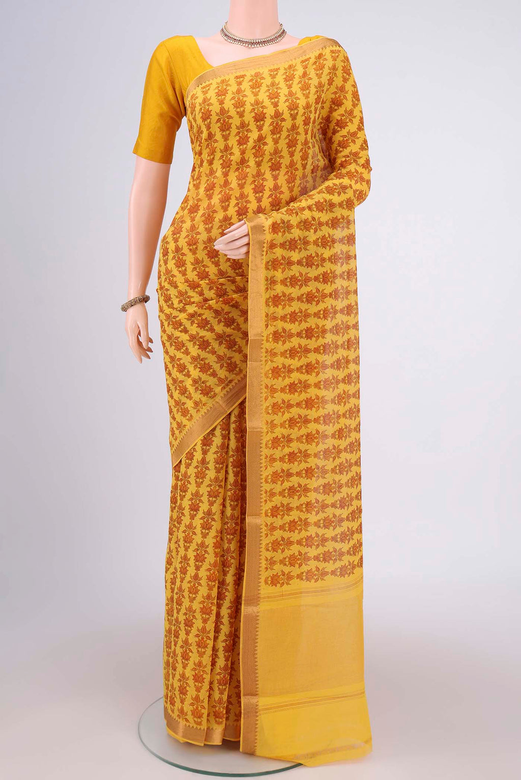 Yellow Mangalagiri Cotton Saree with Printed design on the body and Zari Border.  displayed on a mannequin