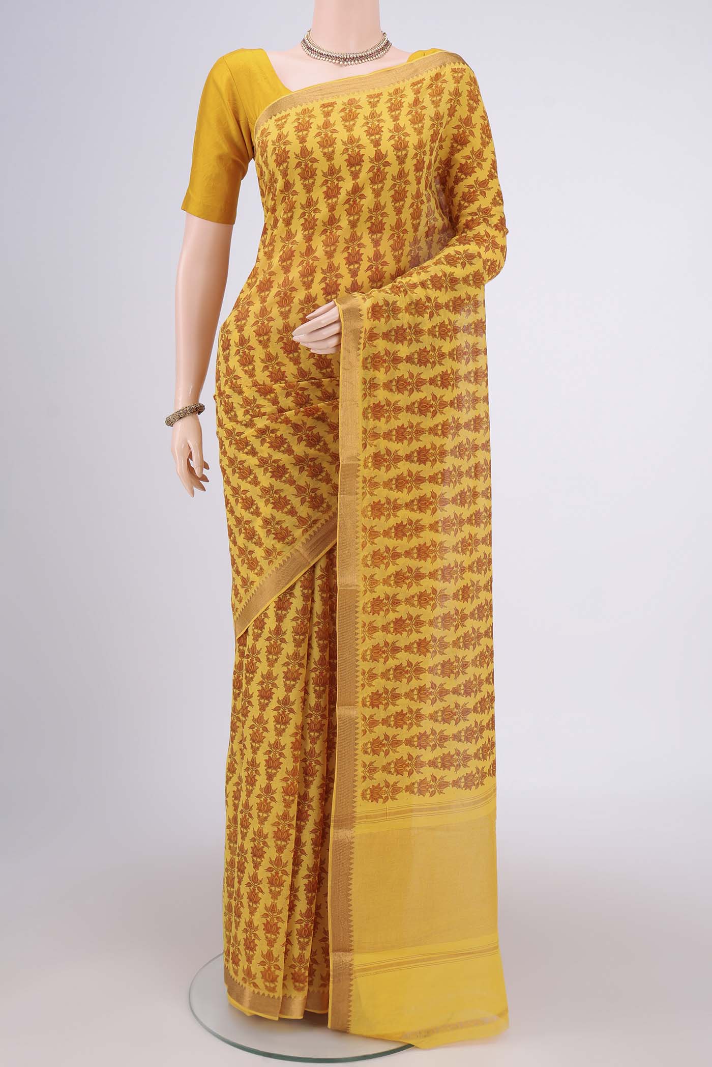 Yellow Mangalagiri Cotton Saree with Printed design on the body and Zari Border.  displayed on a mannequin