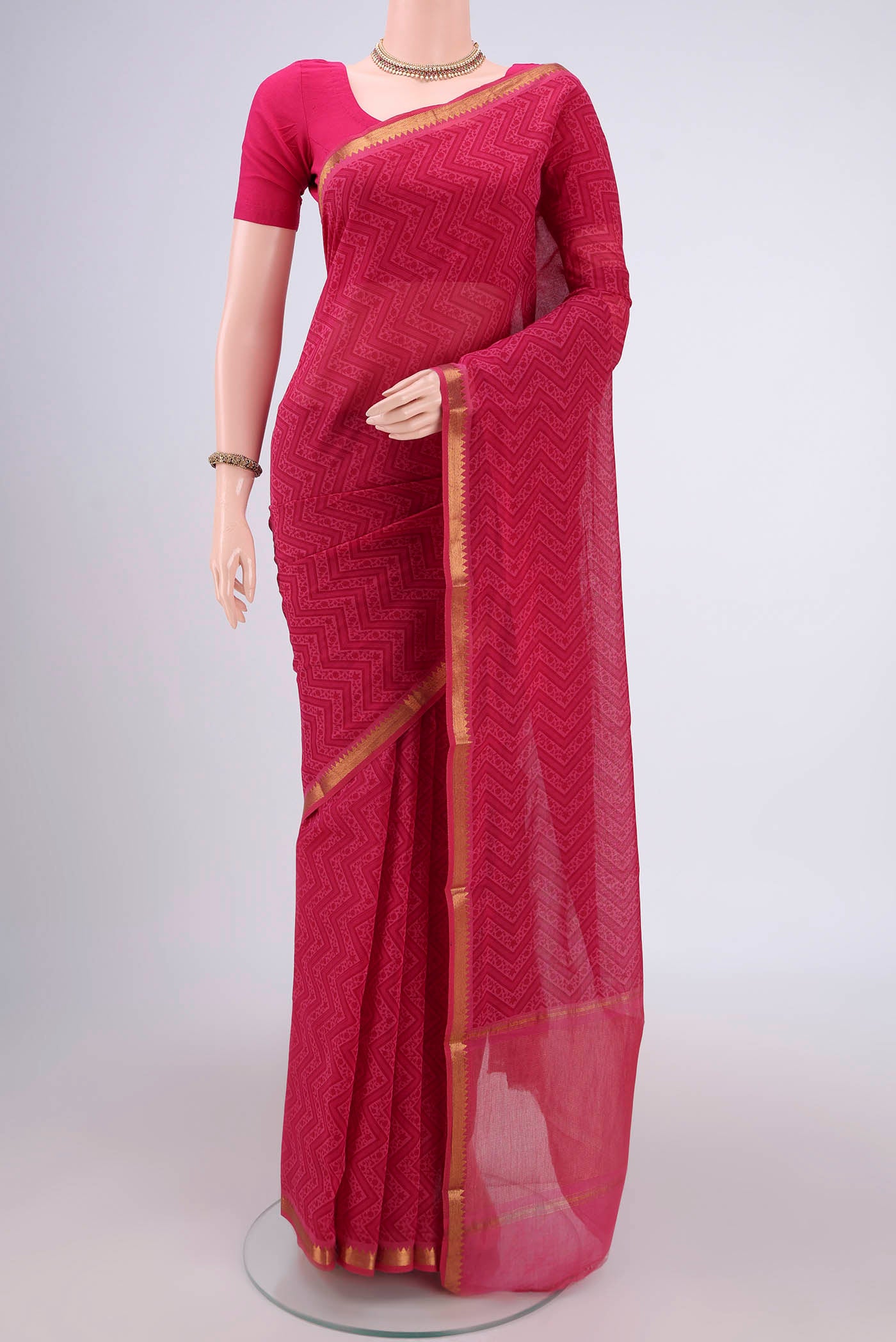 Dark Pink Mangalagiri Cotton Saree with Printed design on the body and Zari Border.  displayed on a mannequin